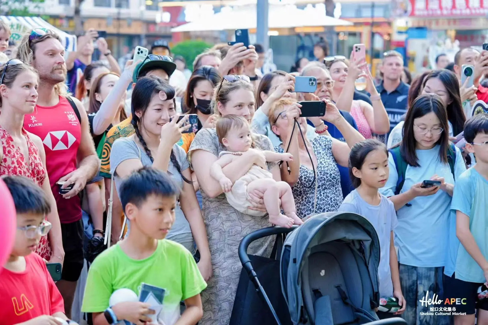 Visitors watching a performance at the Hello APEC cultural market